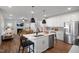 Beautiful kitchen with a center island, stainless steel appliances, open to the living room with fireplace at 1931 Ballard Rd, Fuquay Varina, NC 27526
