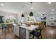 Bright, airy kitchen overlooking the living room, with an island, stainless appliances and natural light at 1931 Ballard Rd, Fuquay Varina, NC 27526