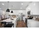 Open kitchen with white cabinets, stainless steel appliances, island seating, and stylish countertops at 1931 Ballard Rd, Fuquay Varina, NC 27526