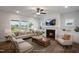 Bright and cozy living room with a fireplace, large windows, and comfortable seating at 1931 Ballard Rd, Fuquay Varina, NC 27526