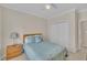 Bedroom with neutral walls, ceiling fan, and a closet with white doors at 1933 Castle Pines Dr, Raleigh, NC 27604