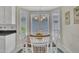 Charming breakfast nook with a round table, seating for four, and bright natural light from the bay windows at 1933 Castle Pines Dr, Raleigh, NC 27604