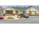 Exterior of the community clubhouse with a roundabout, landscaping, and parking at 1933 Castle Pines Dr, Raleigh, NC 27604