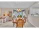 Formal dining area with a chandelier, seating for six, and a glimpse of the bay windows at 1933 Castle Pines Dr, Raleigh, NC 27604