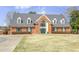 Two-story brick home with green shutters, double front doors, and arched transom window at 1933 Castle Pines Dr, Raleigh, NC 27604