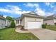 Beautiful home exterior with well-manicured lawn, attached garage, and a welcoming entrance at 1933 Castle Pines Dr, Raleigh, NC 27604