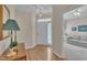 Welcoming foyer with hardwood floors, elegant lighting, and a view into the adjacent living area at 1933 Castle Pines Dr, Raleigh, NC 27604
