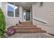 Charming front entrance with brick steps, quaint decor, and a pop of floral color at 1933 Castle Pines Dr, Raleigh, NC 27604