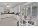 Open kitchen and breakfast nook area featuring white cabinets and a view of living spaces at 1933 Castle Pines Dr, Raleigh, NC 27604