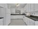 Bright kitchen featuring white cabinets, modern appliances, and stylish countertops at 1933 Castle Pines Dr, Raleigh, NC 27604
