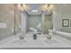 Traditional bathroom with double sinks, a large mirror, wallpapered walls, and skylight at 1933 Castle Pines Dr, Raleigh, NC 27604