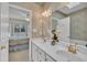 Double sink vanity in the main bathroom with white cabinets at 1933 Castle Pines Dr, Raleigh, NC 27604