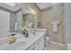 Traditional bathroom with double sinks, a large mirror, and wallpapered walls at 1933 Castle Pines Dr, Raleigh, NC 27604