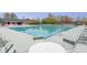 Community pool view with tables, chairs, and lounge chairs at 1933 Castle Pines Dr, Raleigh, NC 27604