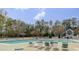 Outdoor pool area with lounge chairs and surrounding mature trees at 1933 Castle Pines Dr, Raleigh, NC 27604