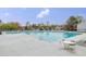 Community pool view with tables, chairs, and lounge chairs at 1933 Castle Pines Dr, Raleigh, NC 27604