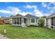 Rear view of the house with a screened porch and well-maintained backyard at 1933 Castle Pines Dr, Raleigh, NC 27604