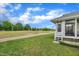 Lawn view from the rear of the house with a porch and a path at 1933 Castle Pines Dr, Raleigh, NC 27604