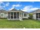 House backyard with a screened porch and lush green grass at 1933 Castle Pines Dr, Raleigh, NC 27604