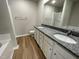 Bathroom features a double vanity with granite countertop, framed mirror and a separate shower at 199 Lotus Ave, Smithfield, NC 27577