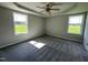 Bedroom with neutral walls, carpet flooring, ceiling fan, and two large windows offering great natural light at 199 Lotus Ave, Smithfield, NC 27577