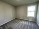 Cozy bedroom with neutral walls, carpet, and a large window providing ample natural light at 199 Lotus Ave, Smithfield, NC 27577