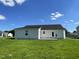 Rear exterior of home showcasing patio and well-maintained lawn under a sunny sky at 199 Lotus Ave, Smithfield, NC 27577