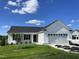 Beautiful, new construction, single story home with white siding, dark roof, and two car garage at 199 Lotus Ave, Smithfield, NC 27577