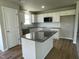 Modern kitchen featuring a stylish island, stainless steel appliances, and ample white cabinetry at 199 Lotus Ave, Smithfield, NC 27577