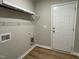 Functional laundry room with shelving, washer/dryer hookups, and convenient access to the outdoors at 199 Lotus Ave, Smithfield, NC 27577