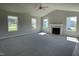 Spacious living room with large windows and a cozy fireplace, perfect for relaxing and entertaining at 199 Lotus Ave, Smithfield, NC 27577