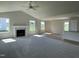 Inviting living room featuring a fireplace, vaulted ceiling, and smooth transition to the kitchen at 199 Lotus Ave, Smithfield, NC 27577
