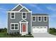 Charming two-story home with gray siding, red front door, and attached two-car garage at 201 Tormore Dr, Sanford, NC 27330