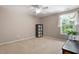 Bright bedroom with carpet, ceiling fan, and a sunny window with white curtains at 208 Station Dr, Morrisville, NC 27560