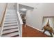 Entryway featuring hardwood floors, a staircase, and neutral wall paint at 208 Station Dr, Morrisville, NC 27560