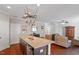 Open kitchen layout with granite counters and stainless steel appliances overlooking the living room at 208 Station Dr, Morrisville, NC 27560