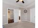 Bedroom with a ceiling fan, neutral colored walls, and two doors leading to a bathroom and closet at 208 Station Dr, Morrisville, NC 27560