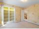 Unique bedroom offers wallpaper, white trim, carpet, closet, and staircase access at 2089 White Pond Ct, Apex, NC 27523