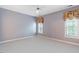 Spacious bedroom features soft carpet, neutral paint, and windows dressed with patterned valances at 2089 White Pond Ct, Apex, NC 27523