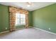 Carpeted bedroom with green walls, floral curtains, and a ceiling fan at 2089 White Pond Ct, Apex, NC 27523