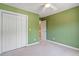 Green bedroom with carpet, ceiling fan, closet, and access to adjoining bathroom at 2089 White Pond Ct, Apex, NC 27523