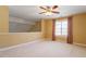 Bonus room offers ceiling fan, soft carpet, natural light, and neutral walls at 2089 White Pond Ct, Apex, NC 27523