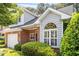 Charming brick home with a well-manicured lawn, attached garage, and beautiful window at 2089 White Pond Ct, Apex, NC 27523