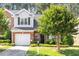 Charming brick home with a well-manicured lawn, attached garage, and lush landscaping at 2089 White Pond Ct, Apex, NC 27523
