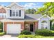 Charming brick home with a well-manicured lawn, attached garage, and lush landscaping at 2089 White Pond Ct, Apex, NC 27523