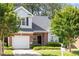 Charming brick home with a well-manicured lawn, attached garage, and lush landscaping at 2089 White Pond Ct, Apex, NC 27523