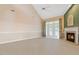 Living room features a fireplace, ceiling fan, and access to the back yard at 2089 White Pond Ct, Apex, NC 27523