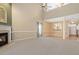 Open concept living room features high ceilings, fireplace, and view into the kitchen at 2089 White Pond Ct, Apex, NC 27523