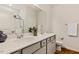 Bathroom with double sink vanity with quartz countertop and warm wood floors at 230 Forest Meadow Ln, Franklinton, NC 27525