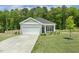 Inviting one-story home boasts a well-kept lawn and a convenient two-car garage for easy parking at 230 Forest Meadow Ln, Franklinton, NC 27525